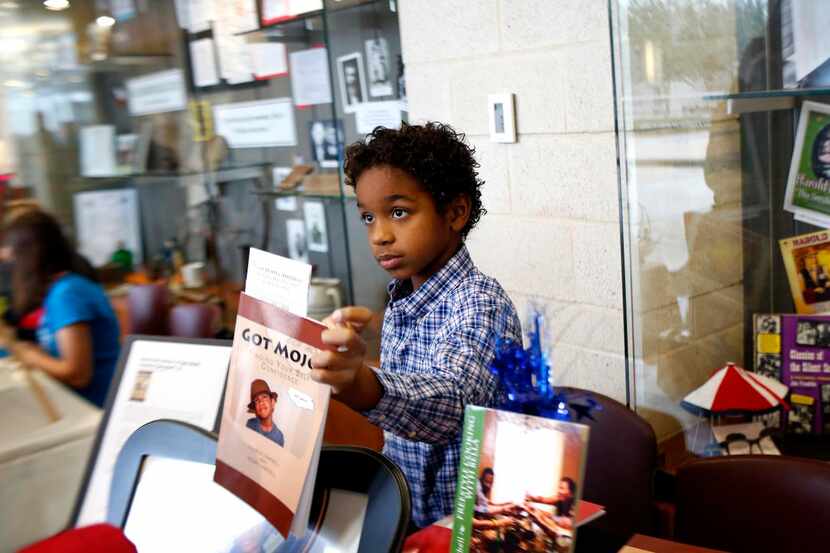 
Charlie Campbell, 8, holds up his book Got Mojo at the recent Allen Book Festival at the...