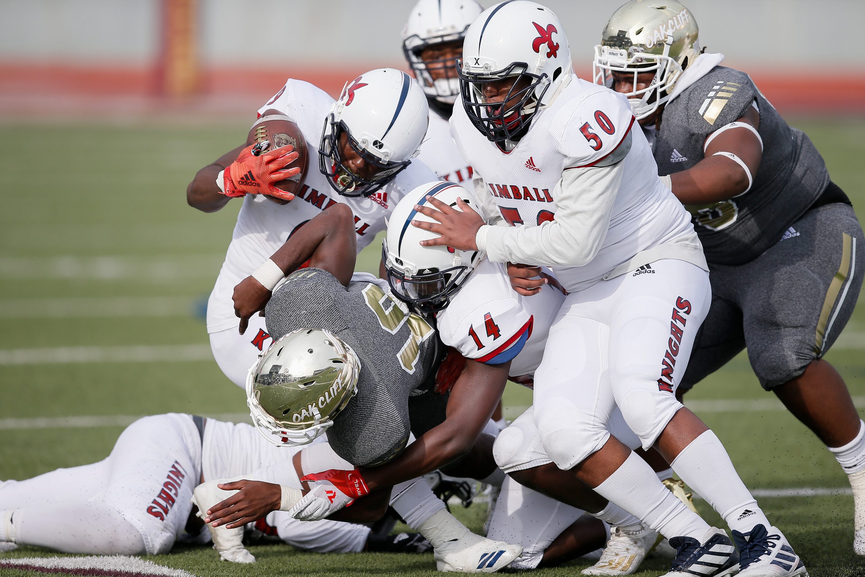 Kimball senior linebacker De’onte Davis (9) strips the ball from South Oak Cliff junior...