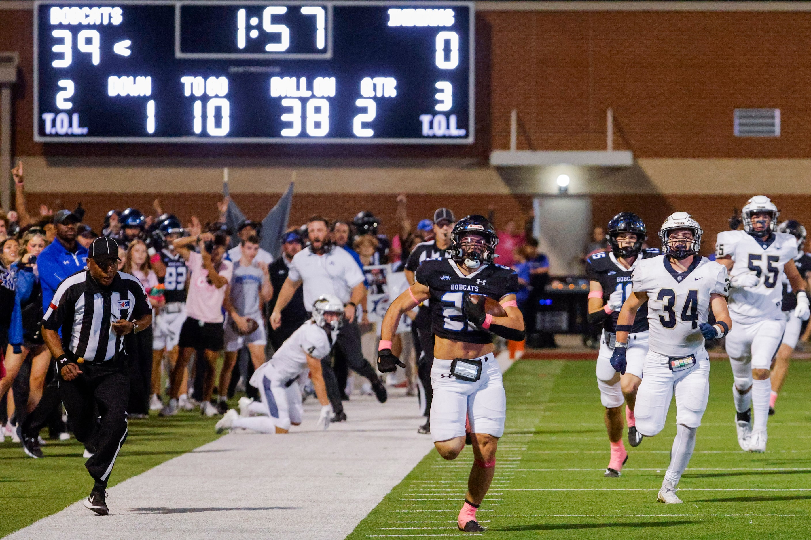 Byron Nelson’s Tucker James (26) runs past Keller high players as he scores a touchdown...