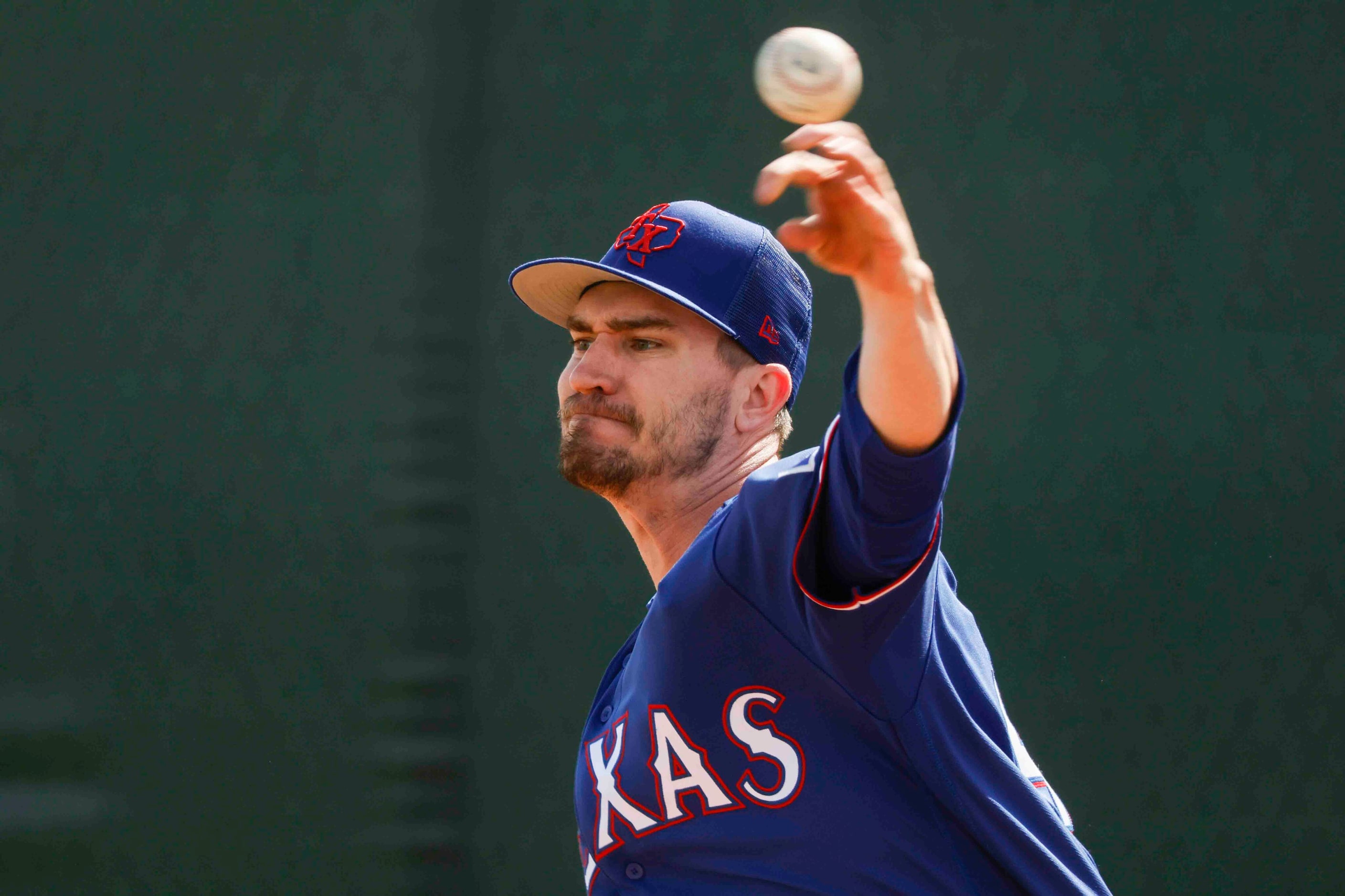 Texas Rangers pitcher Andrew Heaney throws a pitch during a spring training workout at the...