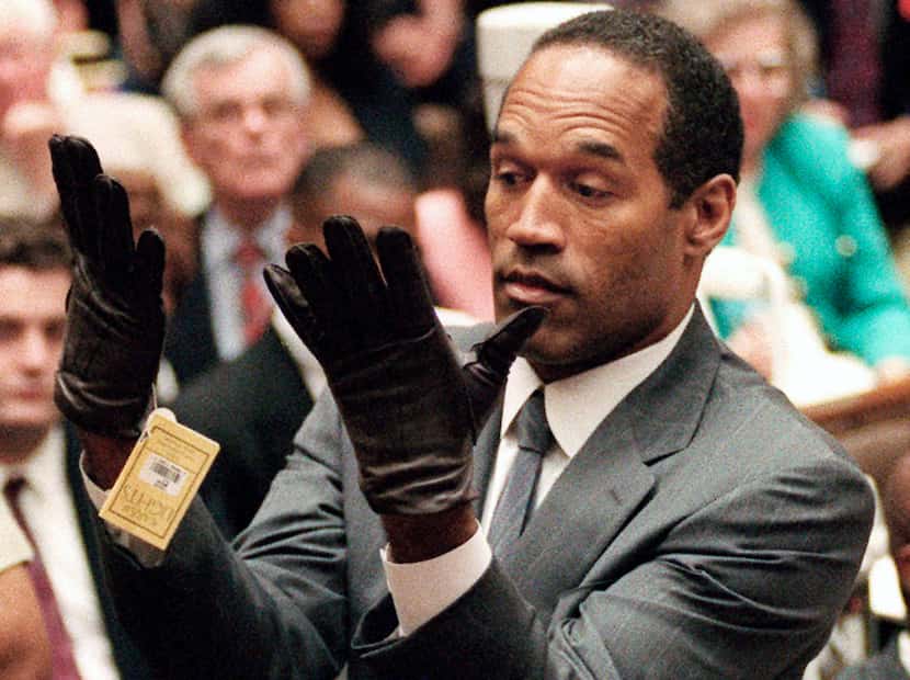 FILE - In this June 21, 1995 file photo, O.J. Simpson holds up his hands before the jury...