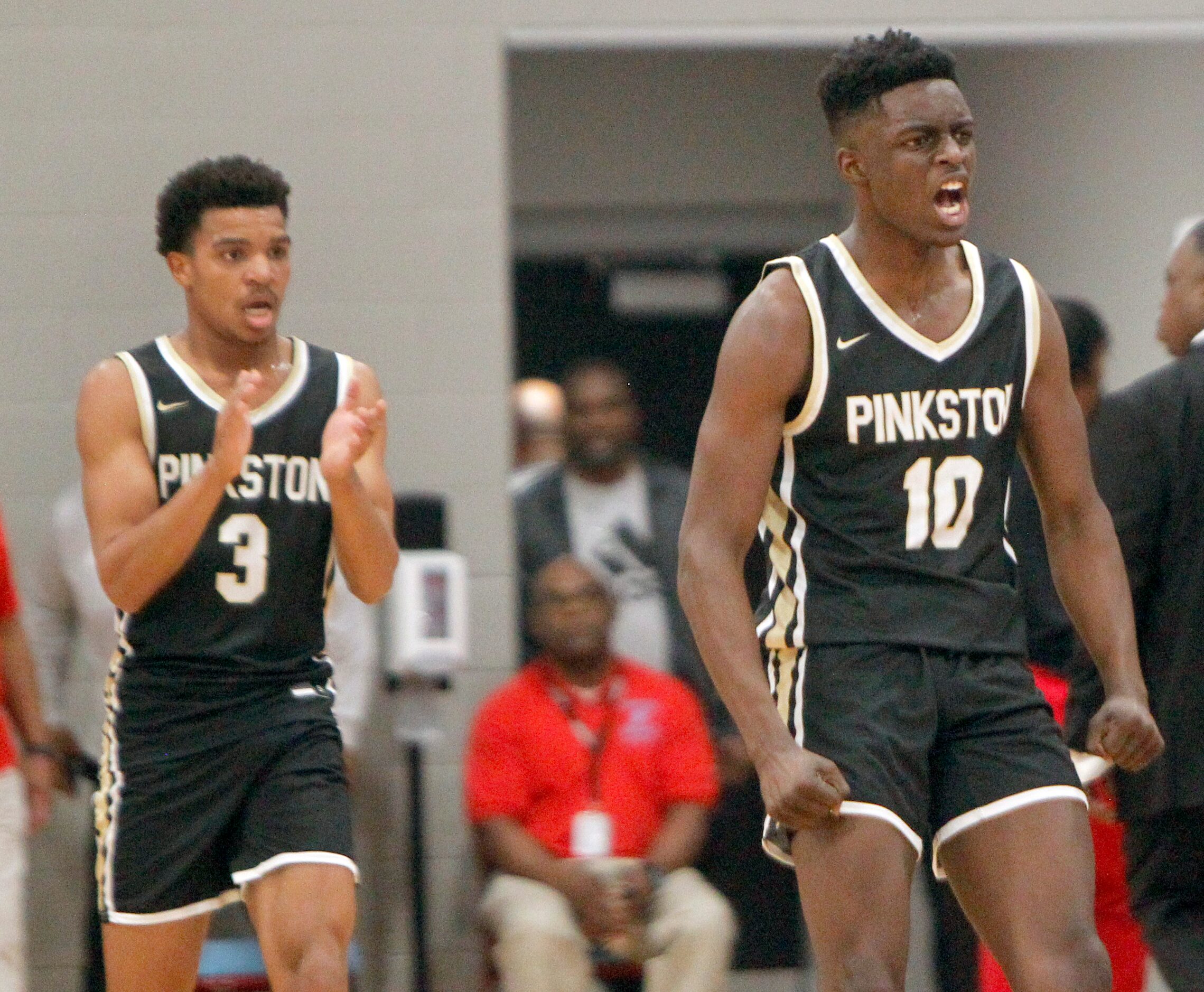 Dallas Pinkston's Rashad Simpson (10) reacts after scoring a buzzer beater ending the first...