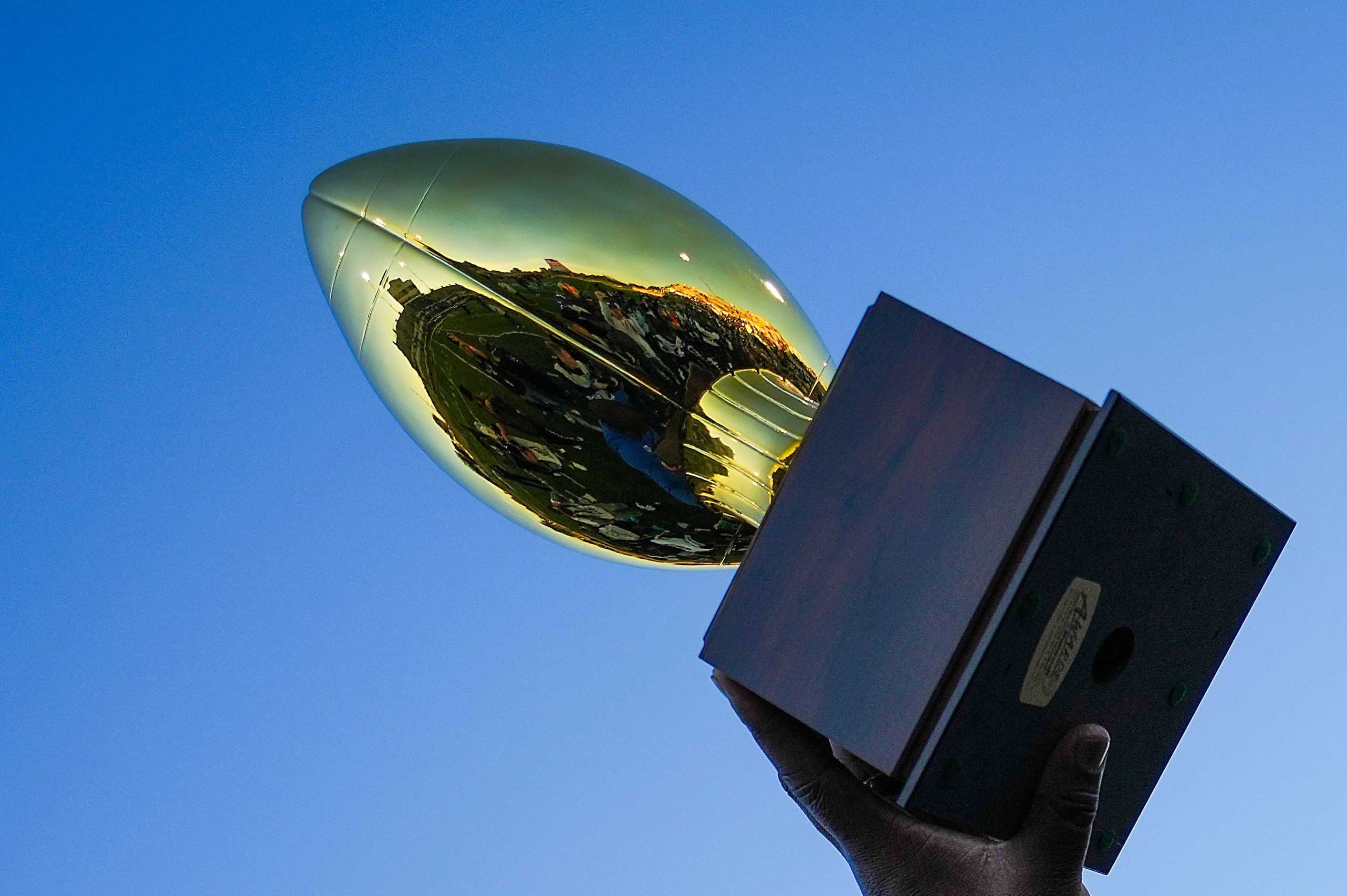 North Crowley head coach Ray Gates raises the game trophy after a victory over Coppell in a...