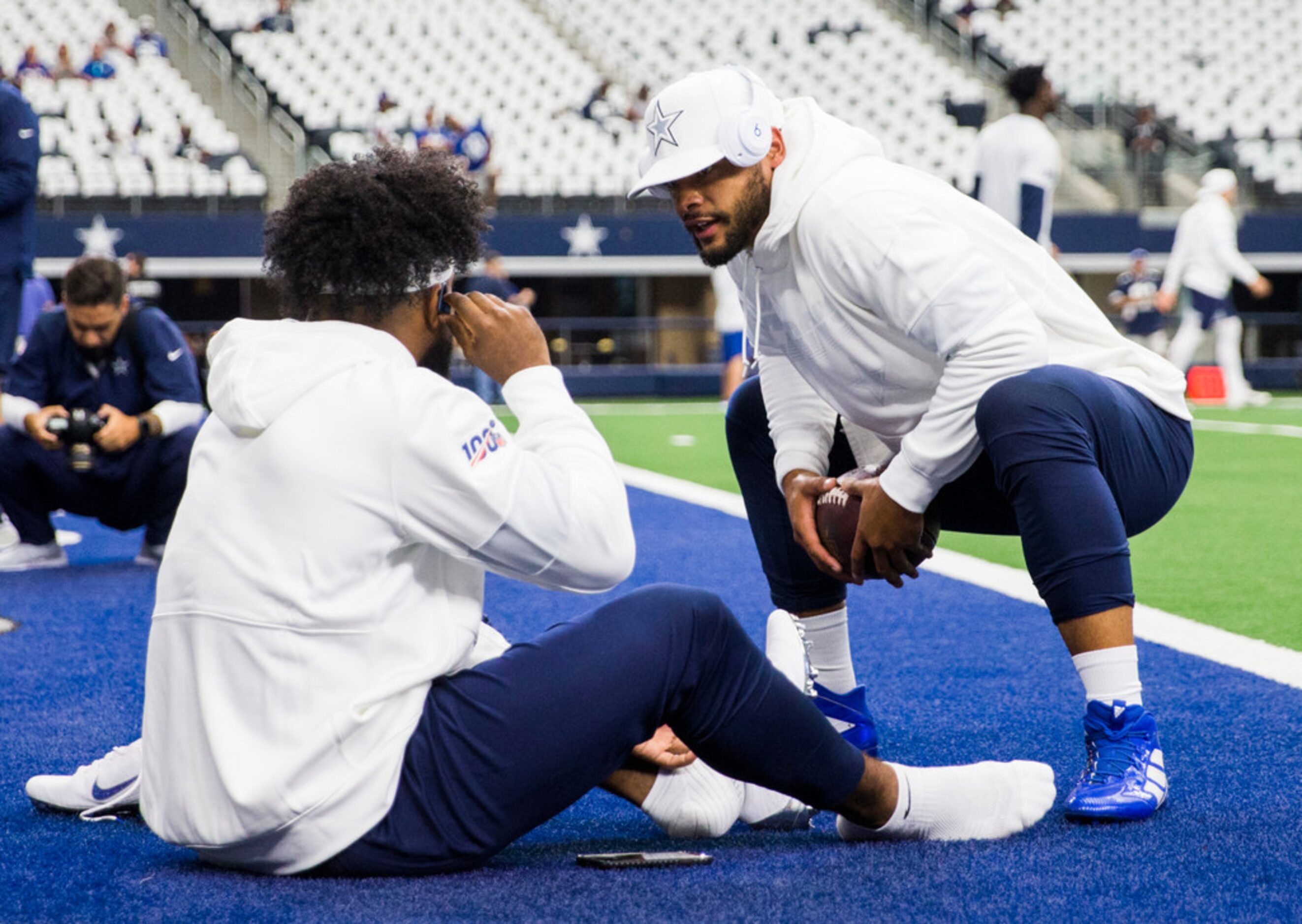 Dallas Cowboys quarterback Dak Prescott (4) greets running back Ezekiel Elliott (21) as they...