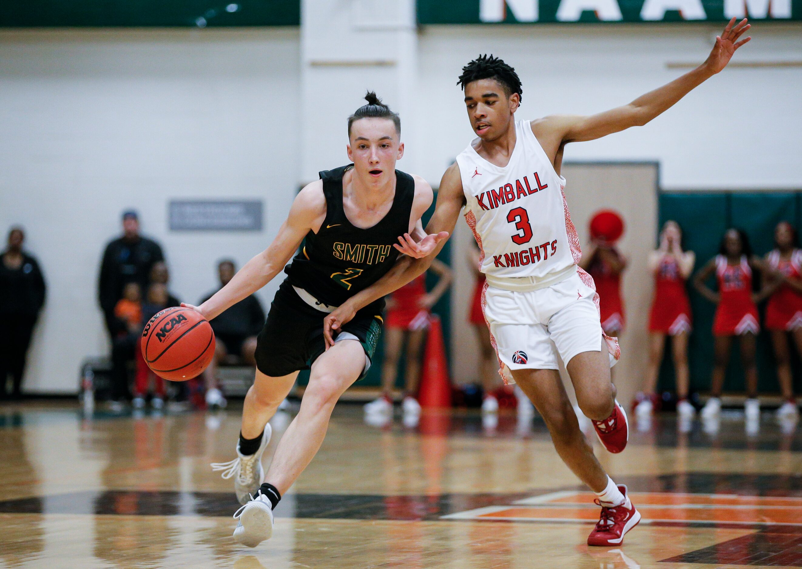 Newman Smith senior Marshal Funches (2) battles Kimball junior DJ Pigford (3) for space...