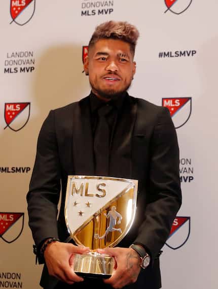Atlanta United soccer player Josef Martinez poses with the trophy after he was presented...