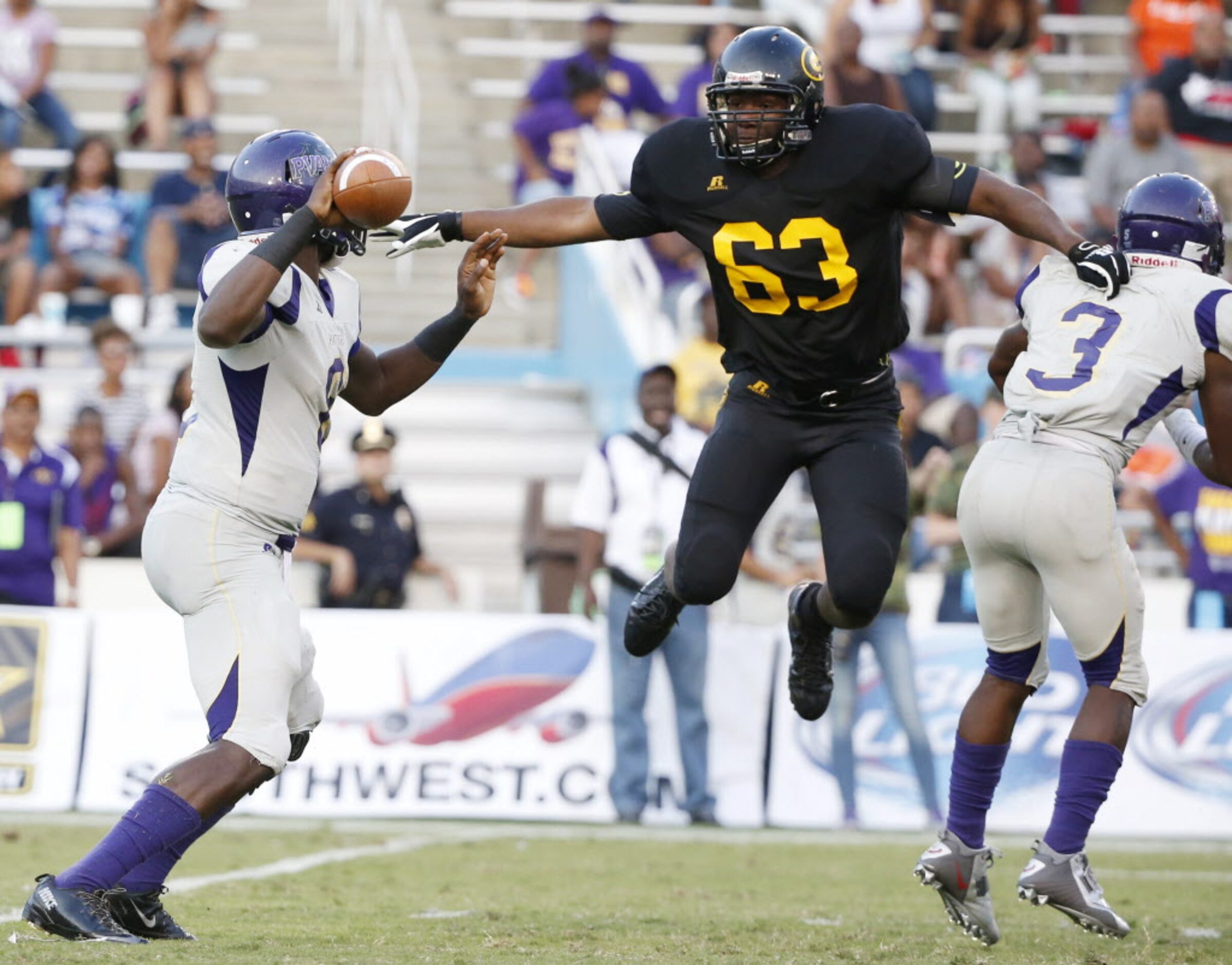 Grambling State defensive lineman Phillip McClain (63) pressures Prairie View A&M...