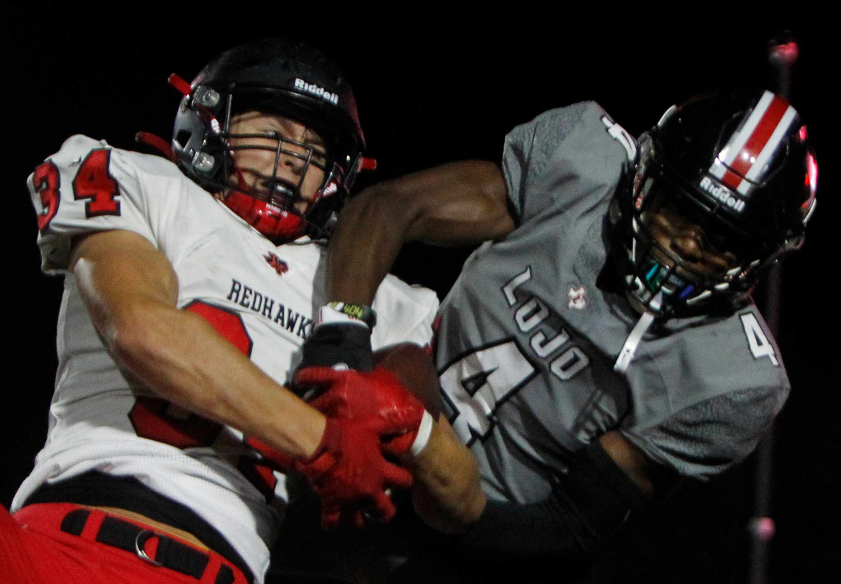 Frisco Liberty safety Sam Wenaas (34), left, wrestles away a pass  intended for Lucas...