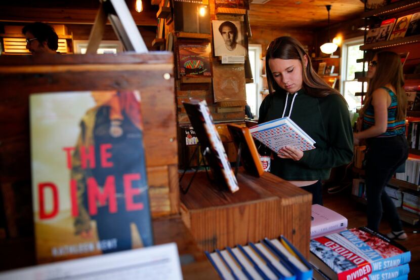 Student Grace McFarland reads a book synopsis at The Wild Detectives bookstore/coffee...