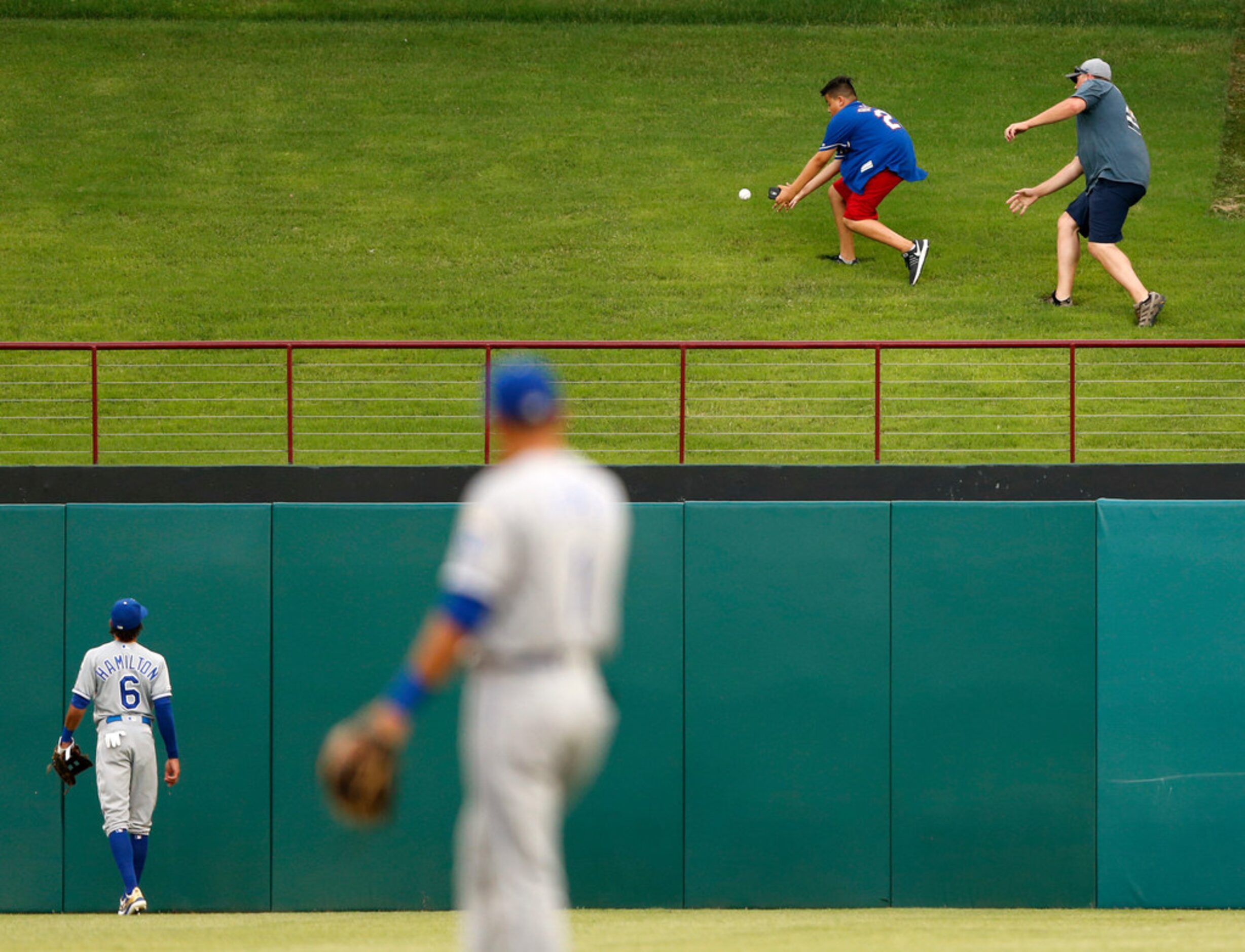 Texas Rangers fans go after a home run ball from Texas Rangers right fielder Shin-Soo Choo...