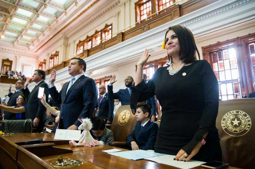 Representative Ana-Maria Ramos, right, is sworn in on opening day of the 86th Texas...