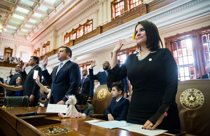 Representative Ana-Maria Ramos, right, is sworn in on opening day of the 86th Texas...