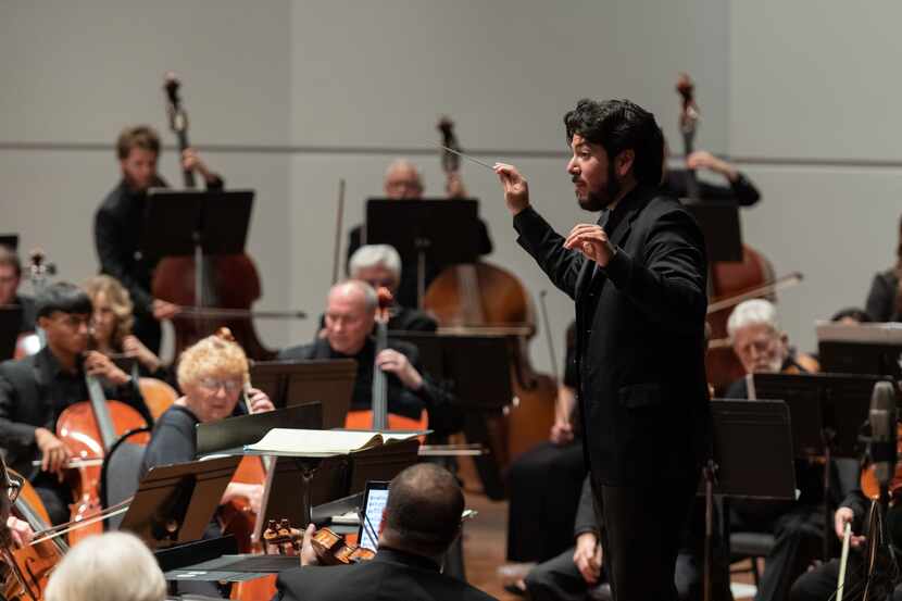 Mesquite Symphony Orchestra Music Director Felix Torres directs musicians during a...
