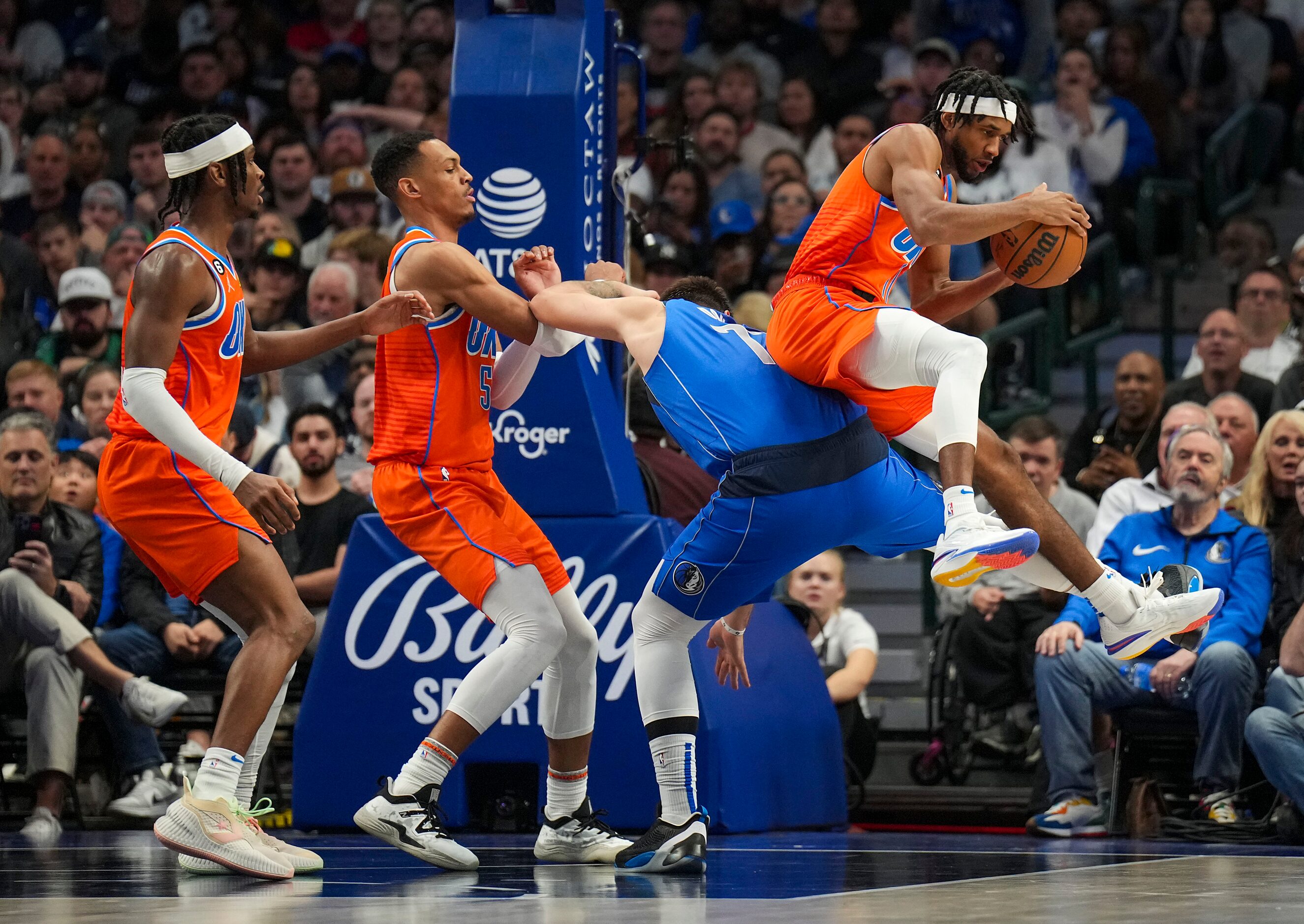 Oklahoma City Thunder forward Luguentz Dort (5) comes down on Dallas Mavericks guard Luka...