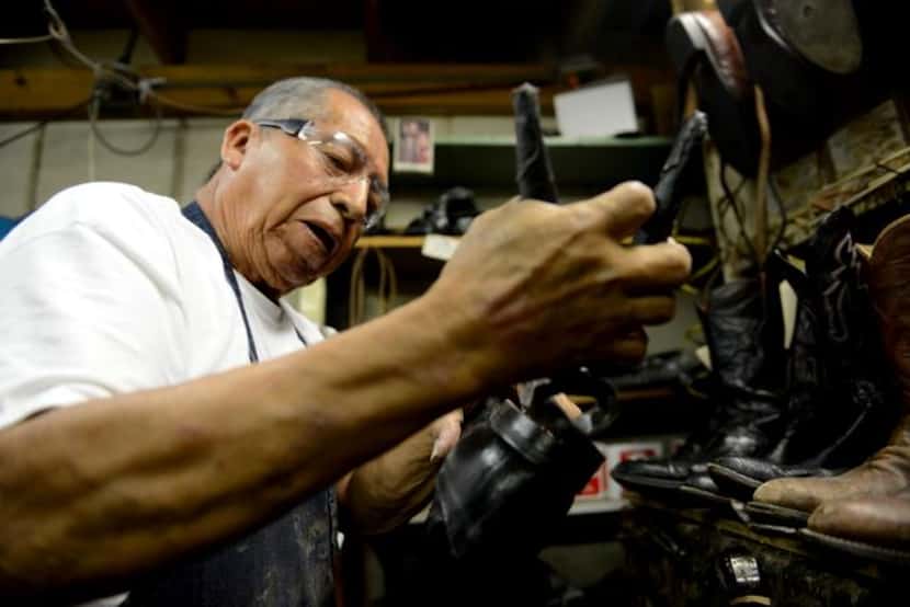 
Raul Torres repairs the sole of a boot in the back room of Messina Shoe Repair.
