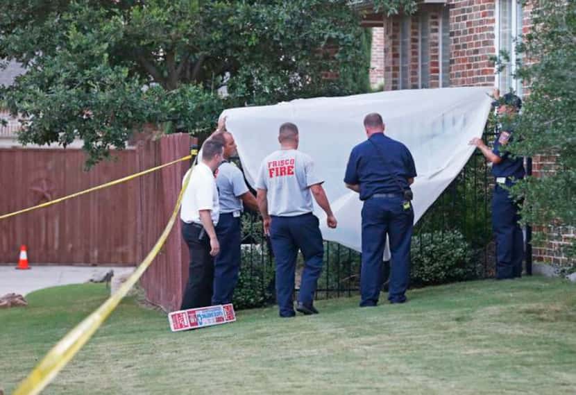 
Frisco fire and police officials covered the back gate as they investigated at a home where...