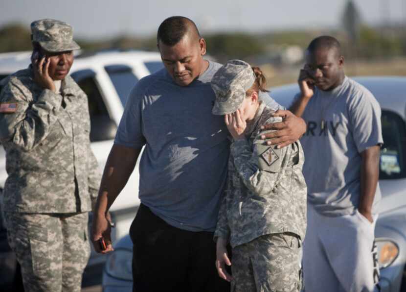 Sgt. Fanuaee Vea (left) embraces Pvt. Savannah Green outside Fort Hood on Nov. 5, 2009. ...