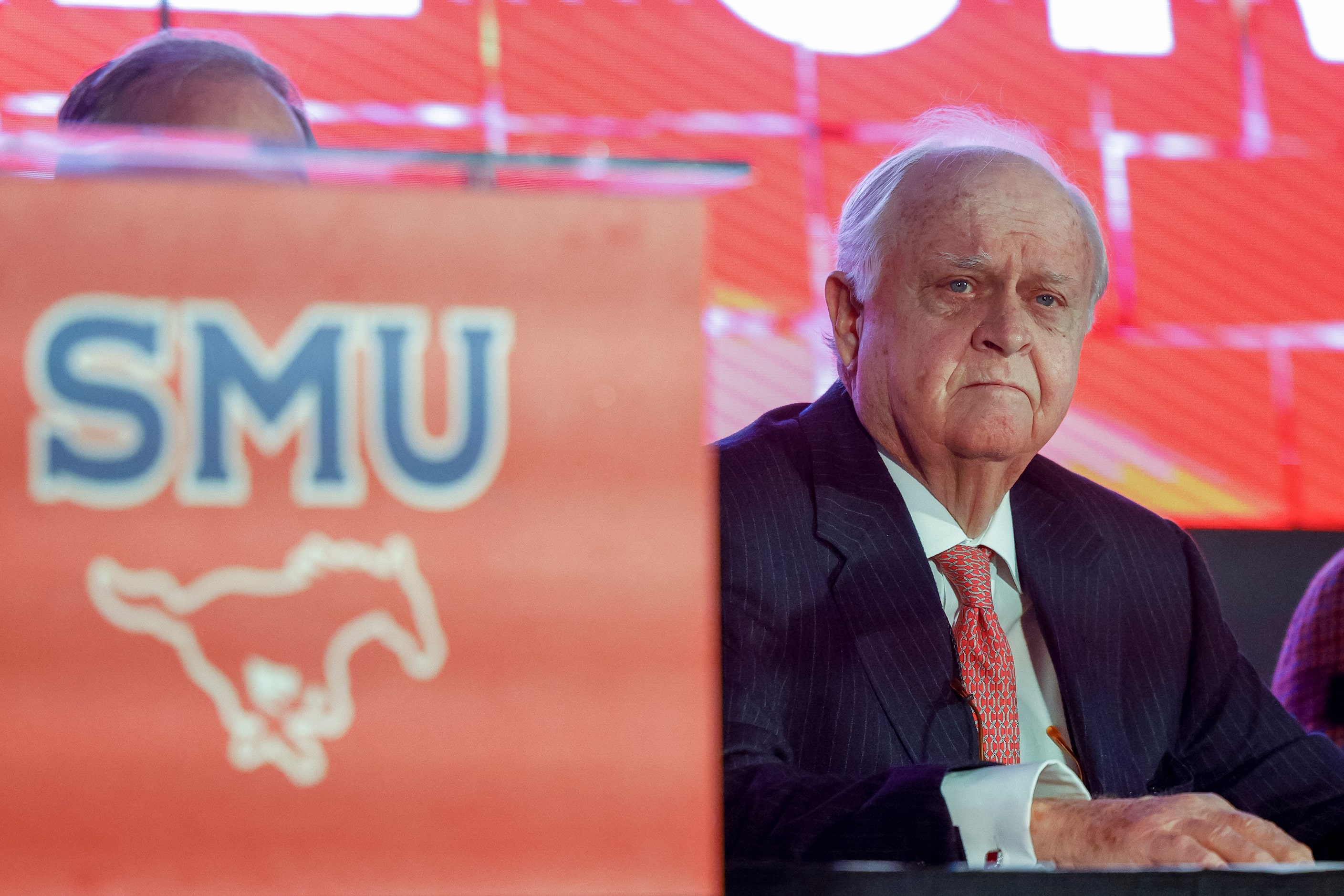 SMU alumnus Gerald J. Ford watches a video during a press conference announcing a $50...