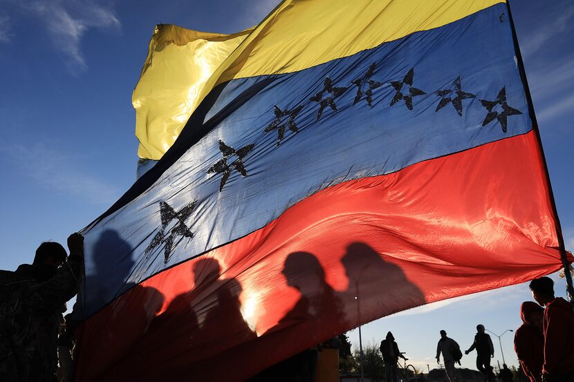 Migrants gather along the banks of the Rio Grande on Tuesday, Nov. 15, 2022, in Ciudad...