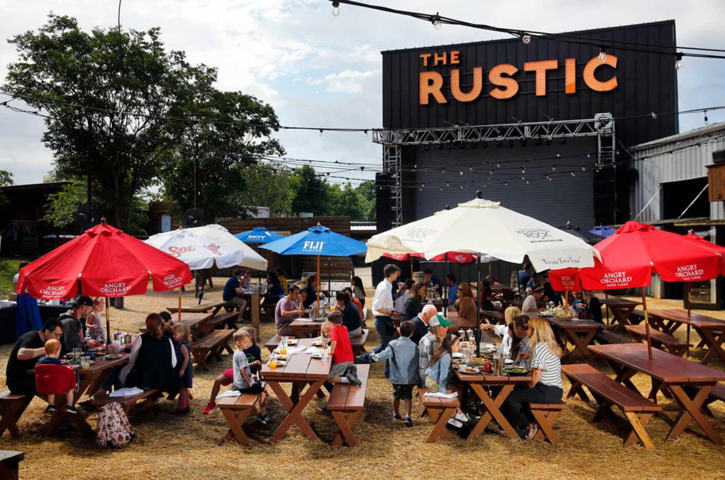 Families enjoy the warm sunshine on the back patio area of The Rustic on Howell Street in...