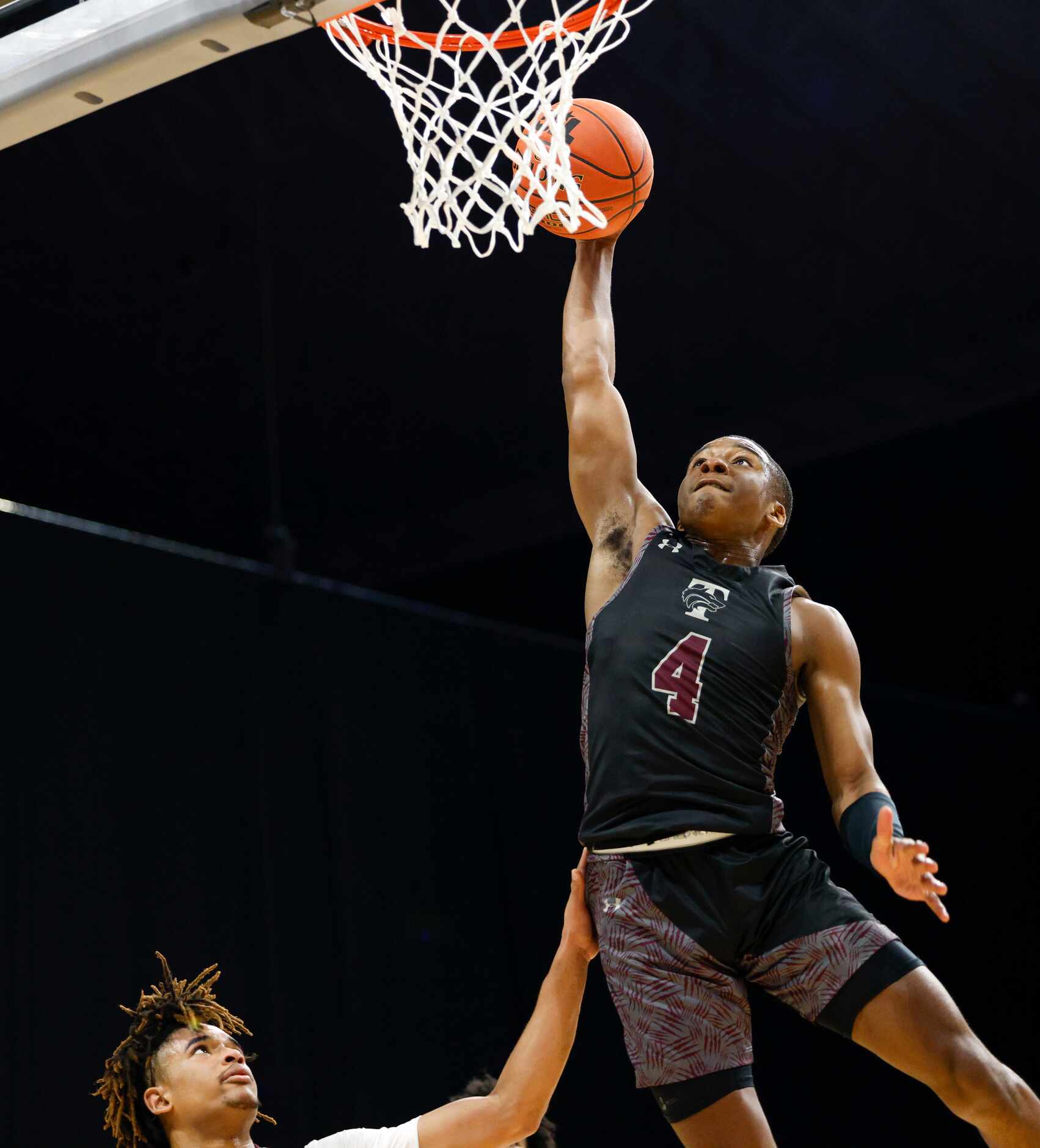 Beaumont United guard Kayde Dotson (11) watches as Mansfield Timberview guard Donovan O'Day...