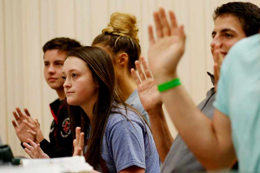 
Kayleigh Grant (center) responds to a question in seminary class. In the Collin County...