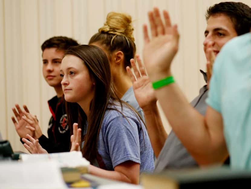 
Kayleigh Grant (center) responds to a question in seminary class. In the Collin County...