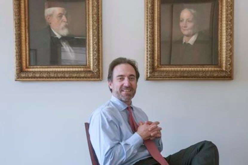 
Immigration attorney Paul Zoltan, with portraits of his Hungarian great-grandparents in his...