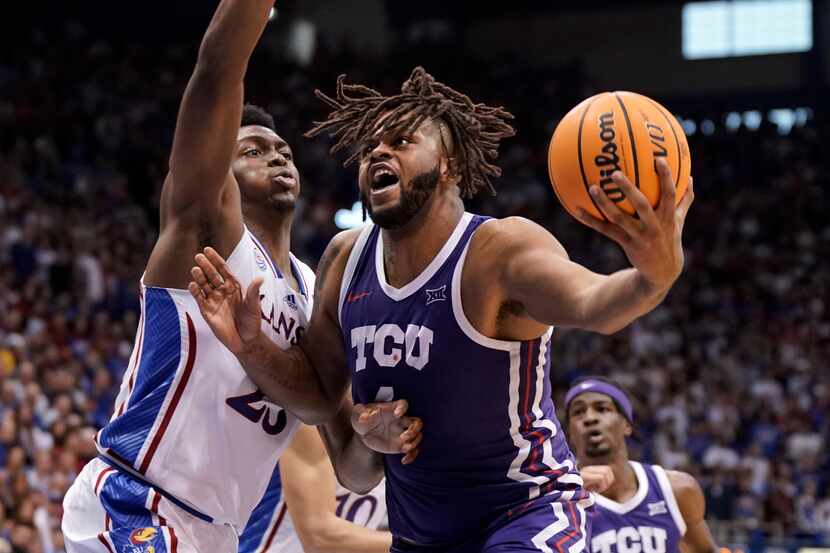 TCU center Eddie Lampkin Jr. (4) works his way inside against Kansas center Ernest Udeh Jr....