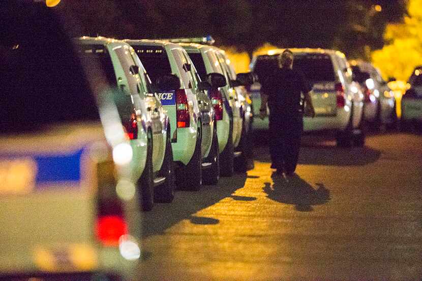  Police gather at the intersection of Interstate 45 and E Palestine Street, where police...