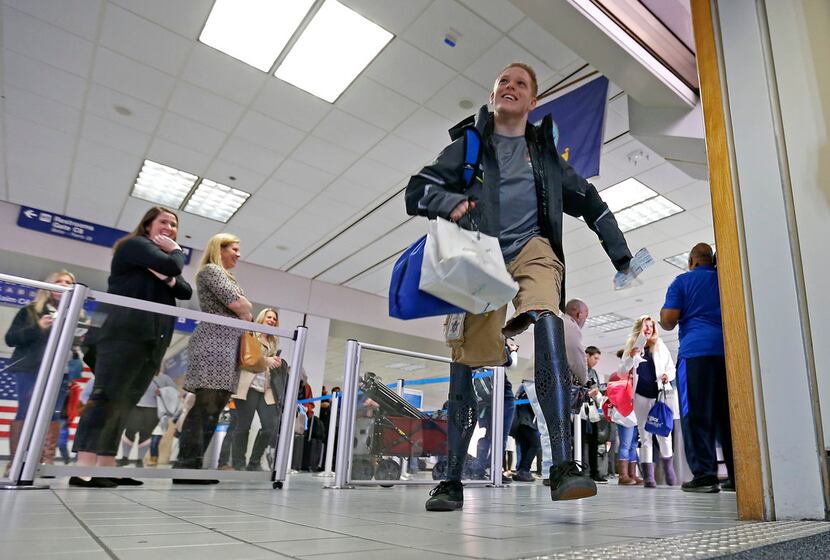 Cody McCasland, of Keller, Texas, 16, walks into the gate to board an American Airlines jet...