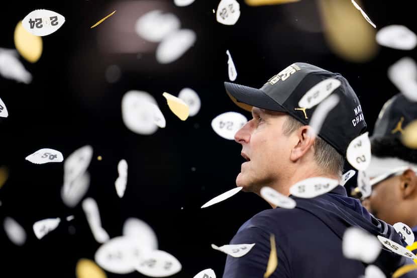 Michigan head coach Jim Harbaugh celebrates after their win against Washington in the...