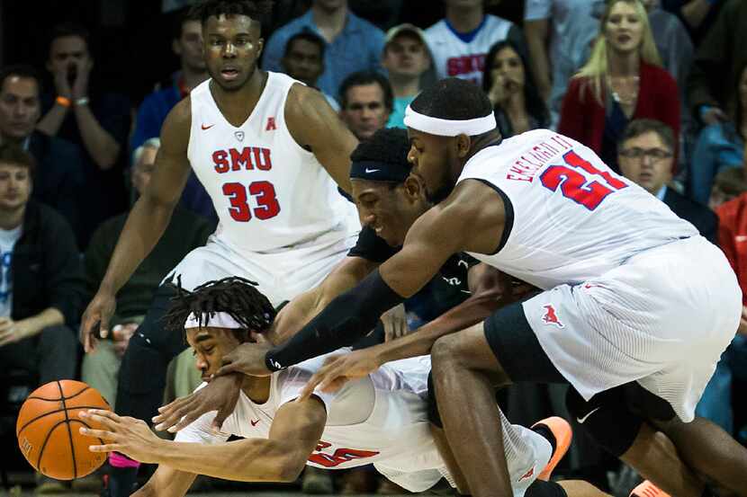 SMU guard Jarrey Foster (10) and SMU guard Ben Emelogu II (21) fight for a loose ball...