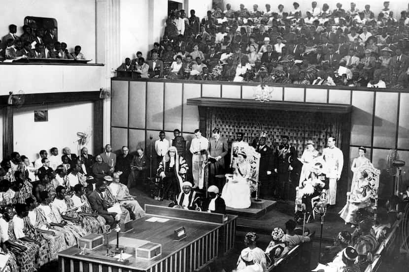 The Duchess of Kent, seated center on dais, reads a message from the Queen of England in the...