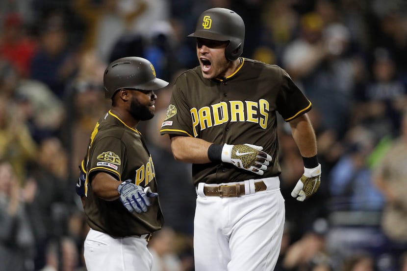 San Diego Padres' Ian Kinsler, right, reacts with teammate Manuel Margot after hitting a...