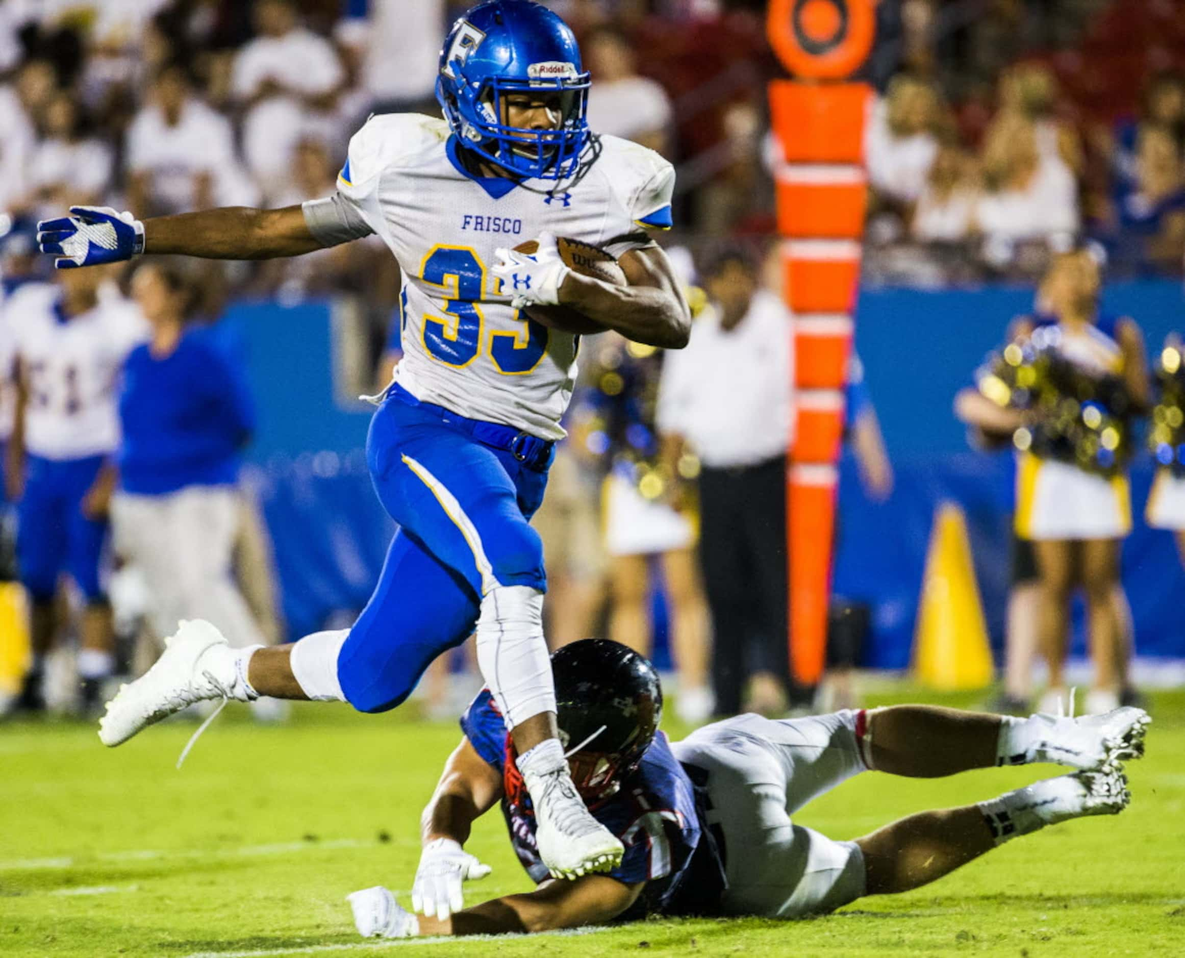 Frisco fullback Idrees Ali (33) escapes a tackle by Frisco Centennial defensive back Brock...