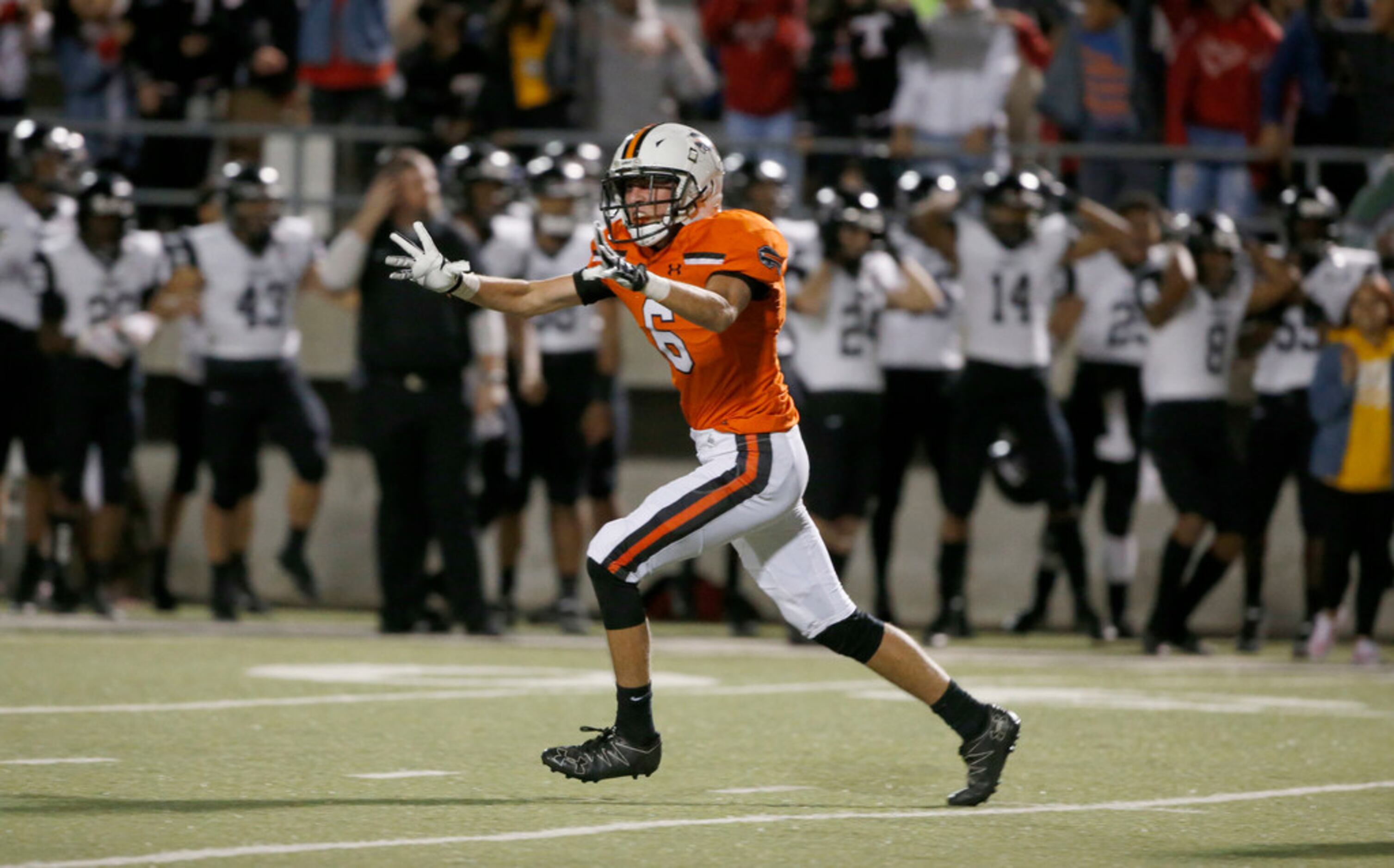 Haltom's Aaron Ellis (6) celebrates a missed Euless Trinity field goal in the closing...