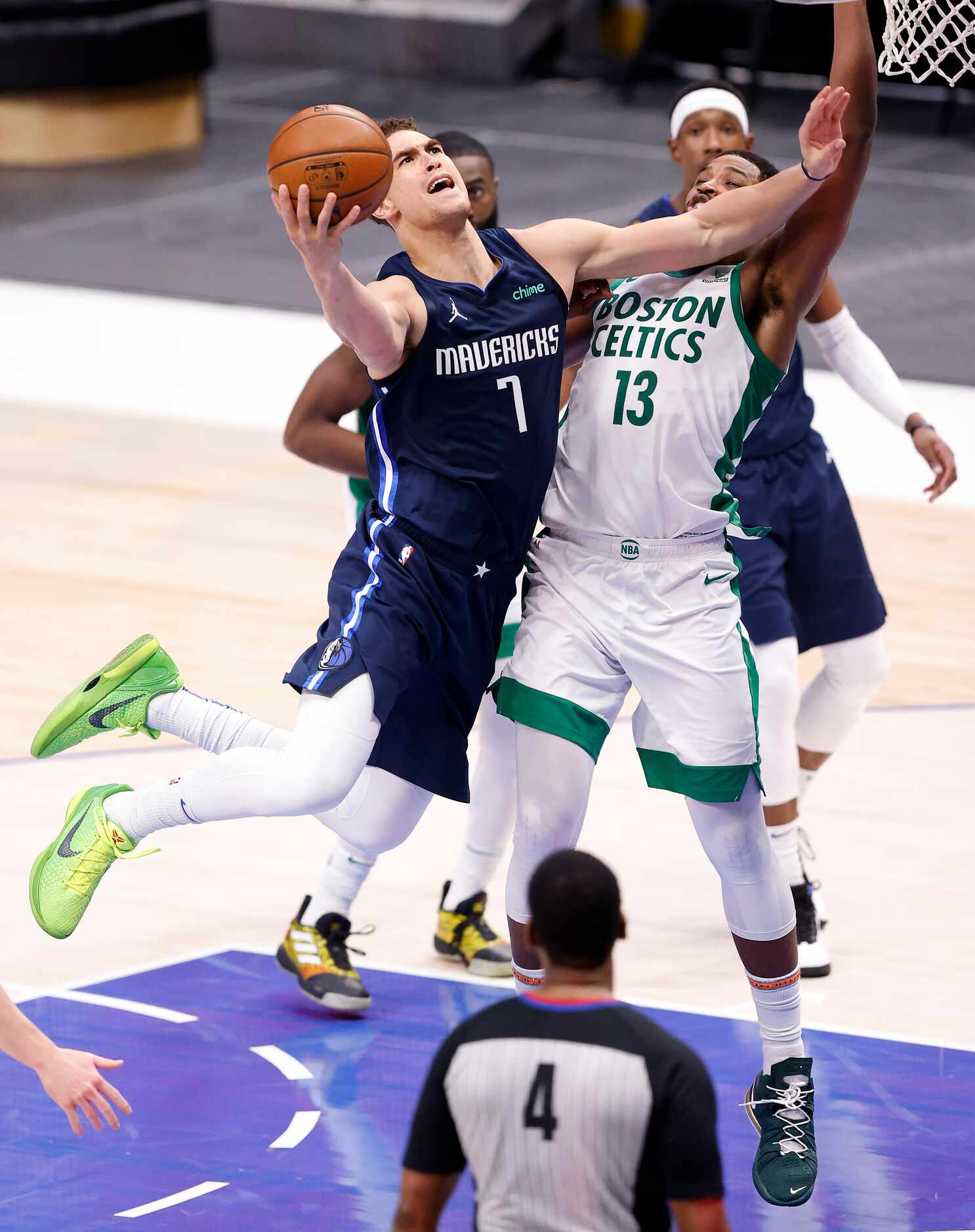 Dallas Mavericks center Dwight Powell (7) lays up a shot as he fights off Boston Celtics...