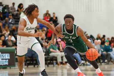 Waxahachie high’s Jeremiah Rucker (left) defends against  Mansfield Lake Ridge high’s Ehi...