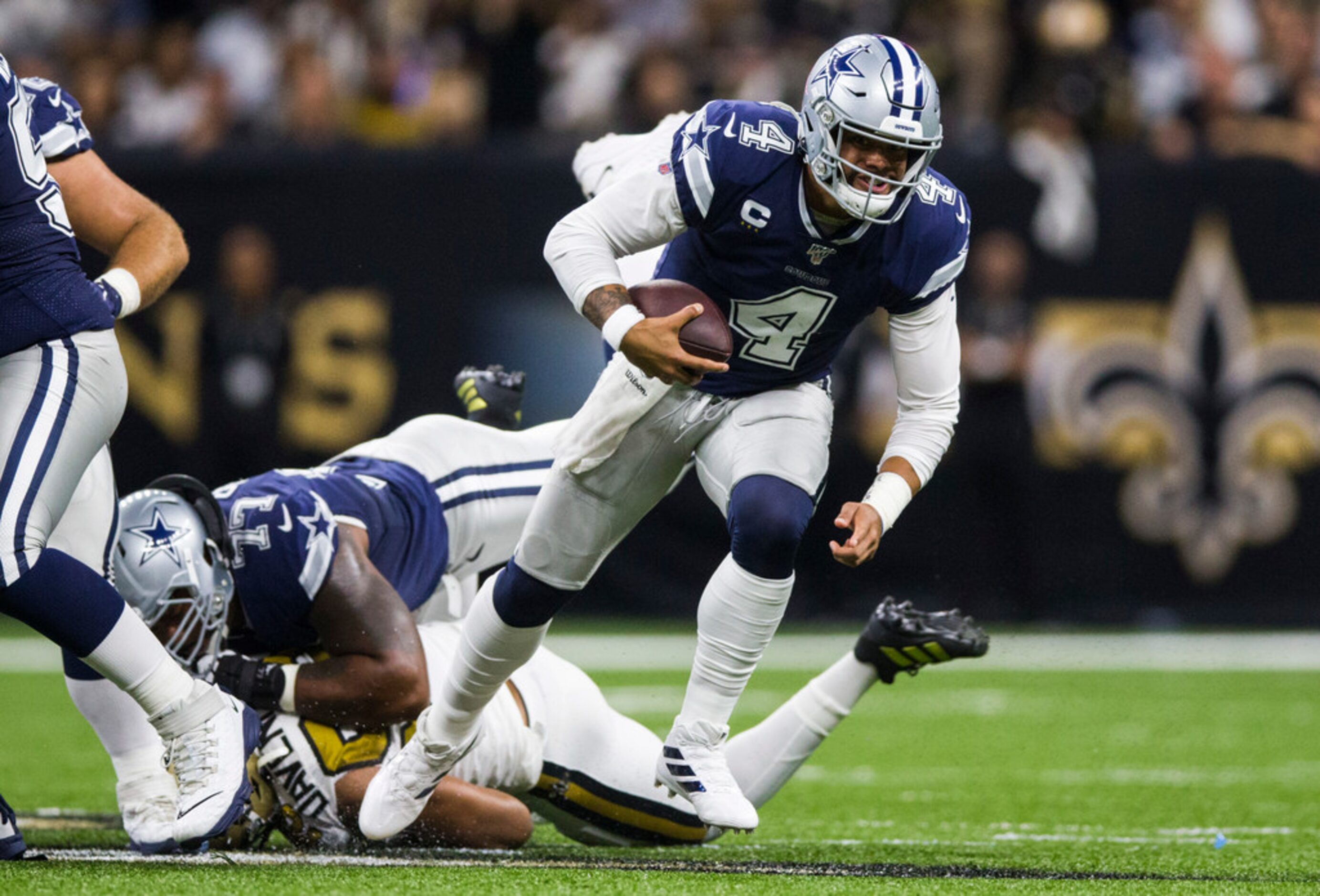 Dallas Cowboys quarterback Dak Prescott (4) runs the ball during the first quarter of an NFL...