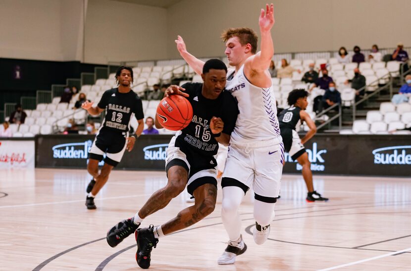 Dallas Christian College's Tilyr Hobson (15) attempts to drive past Abilene Christian...