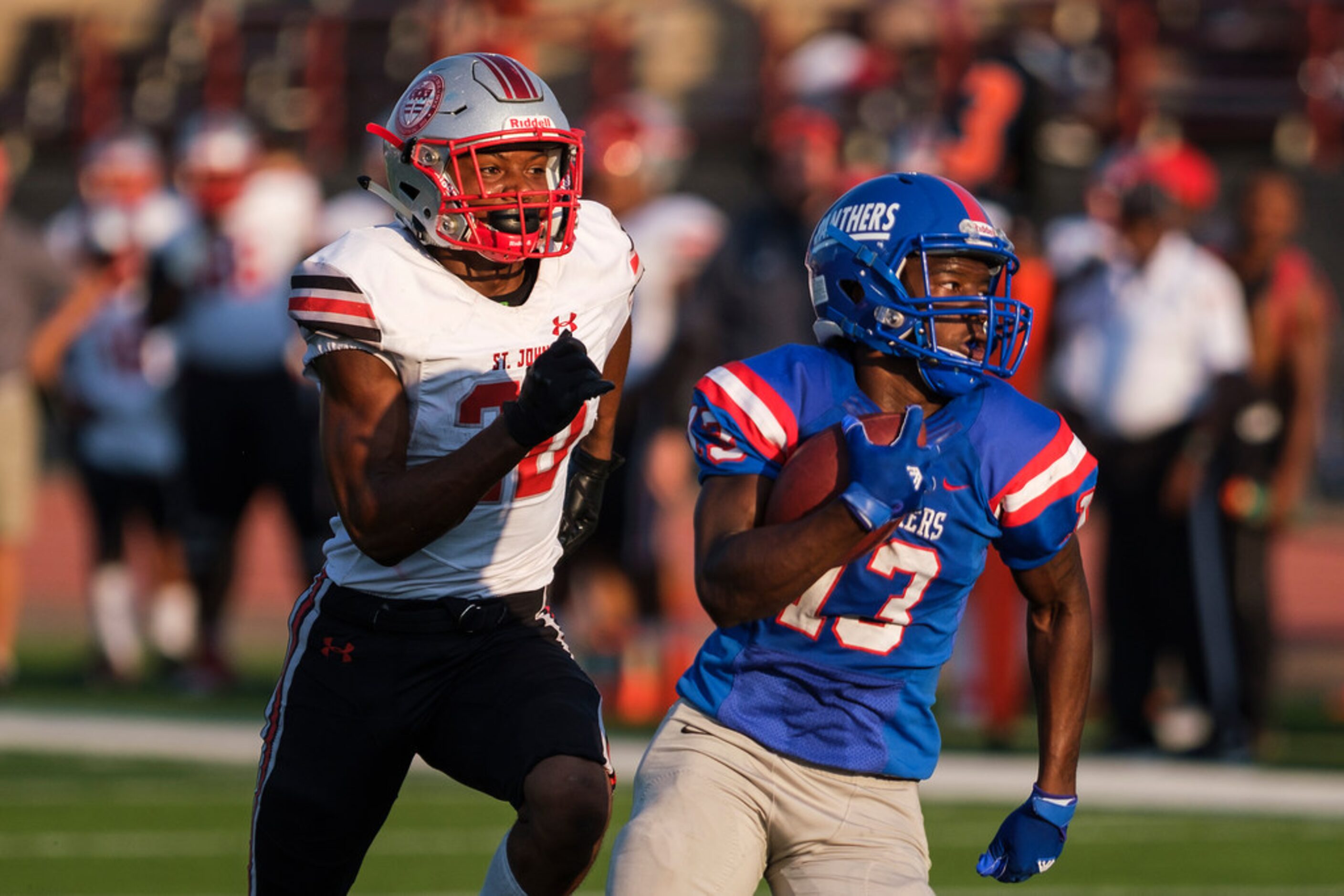 Duncanville wide receiver Roderick Daniels (13) races past St. John's College (D.C.)...