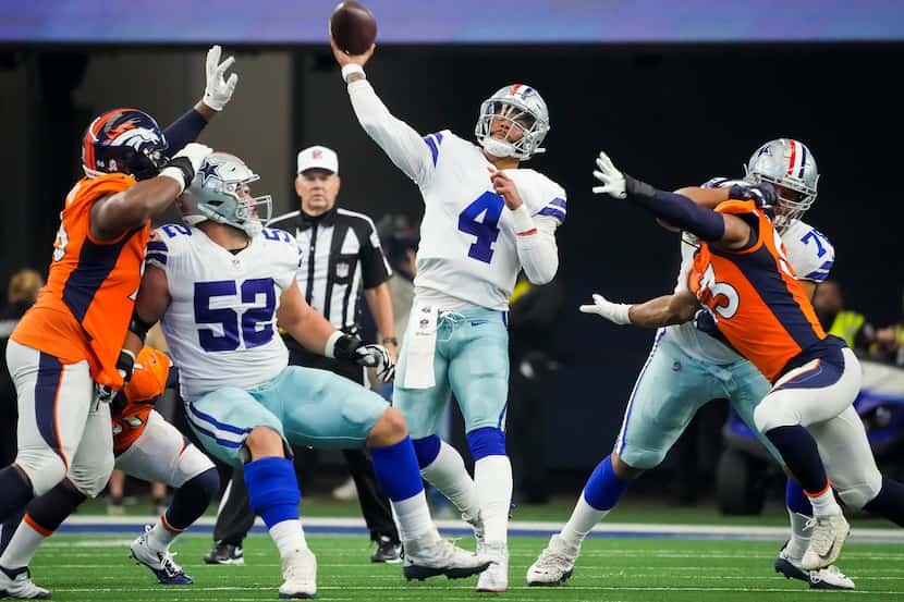 Dallas Cowboys quarterback Dak Prescott (4) throws a pass as guard Connor Williams (52) and...