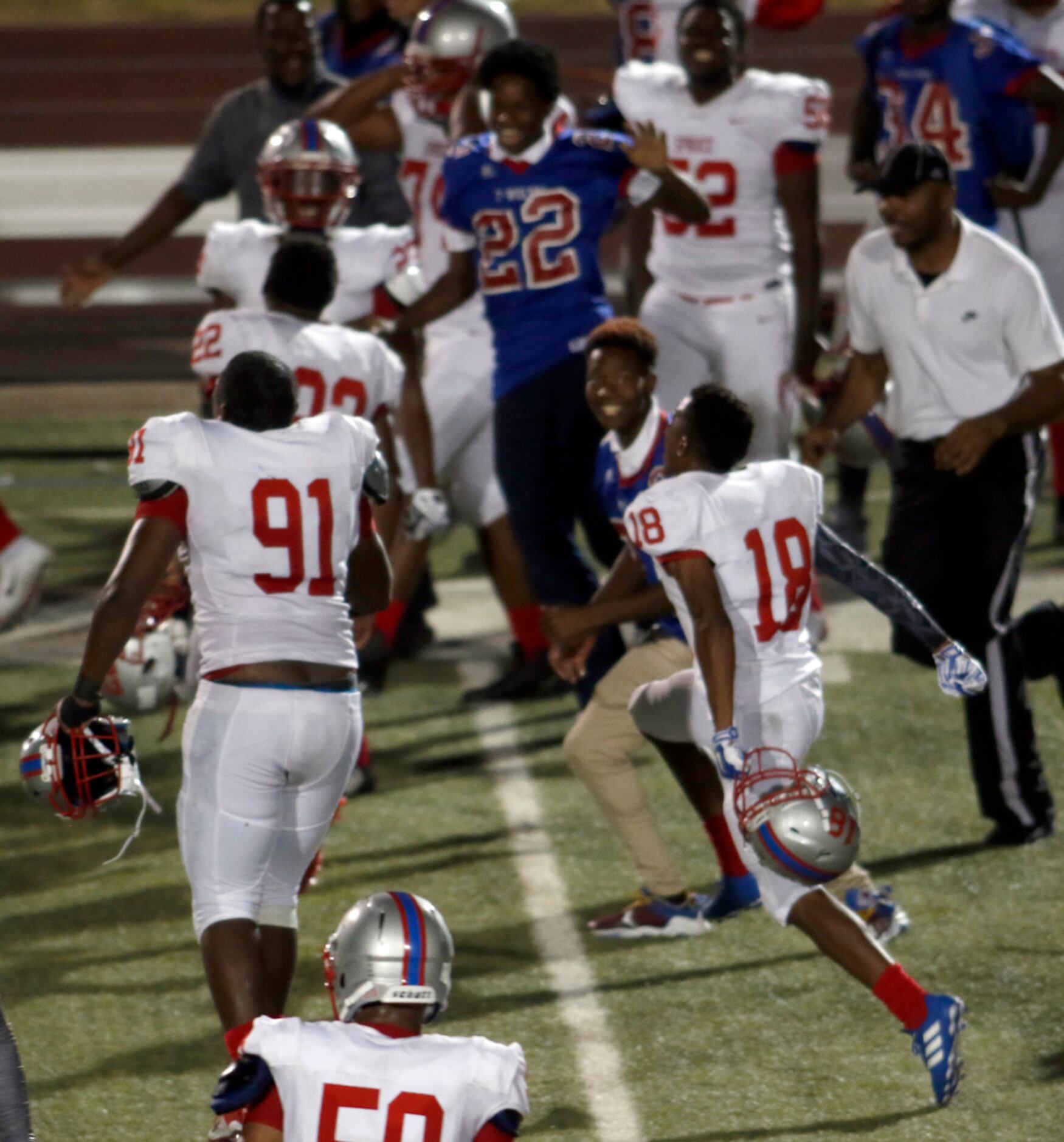 Spruce defensive back Anthony Hodge (18) leaps to join the sideline celebration following...