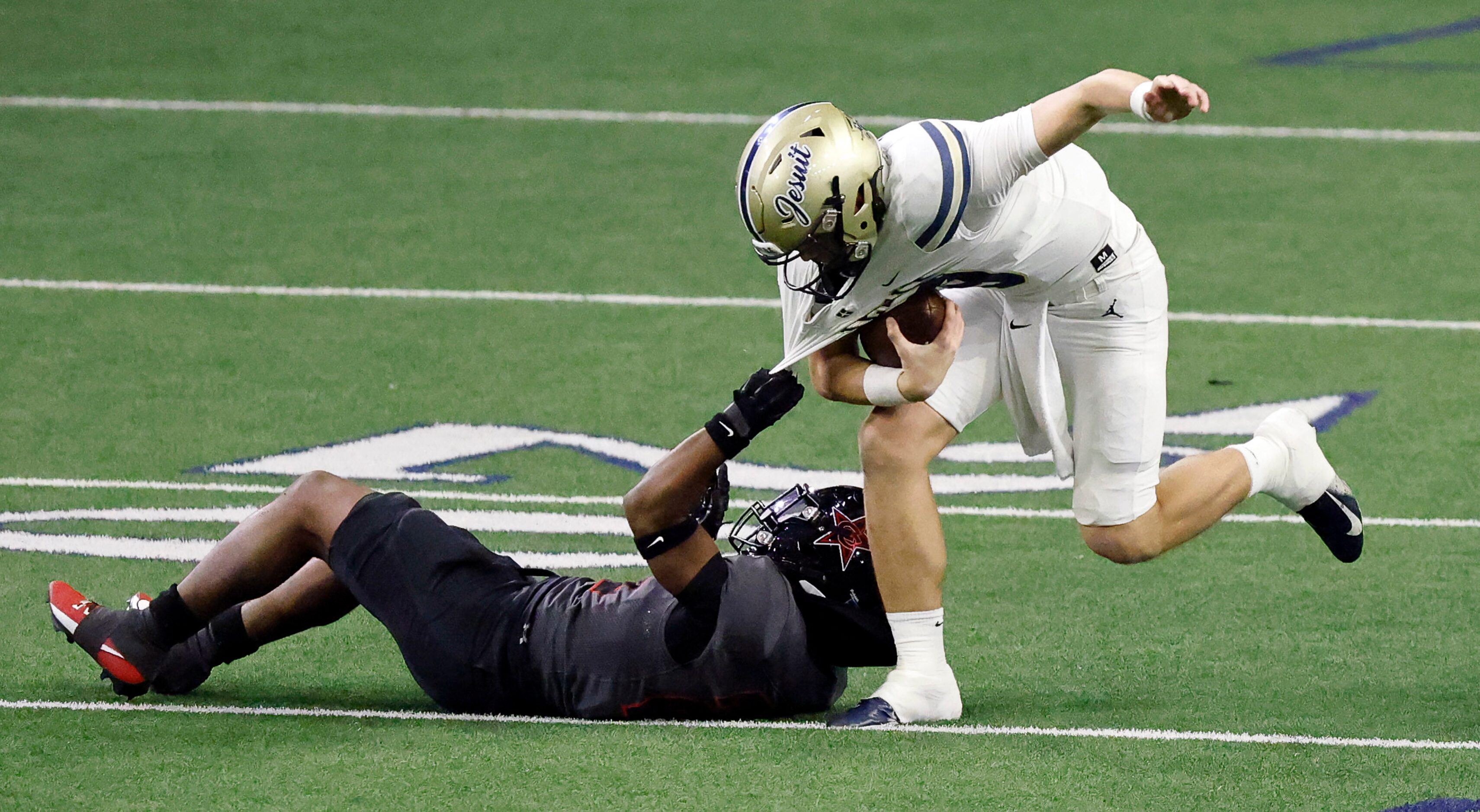 Coppell defensive lineman TJ Smith (29) sacks Jesuit quarterback Charlie Peters (9) during...