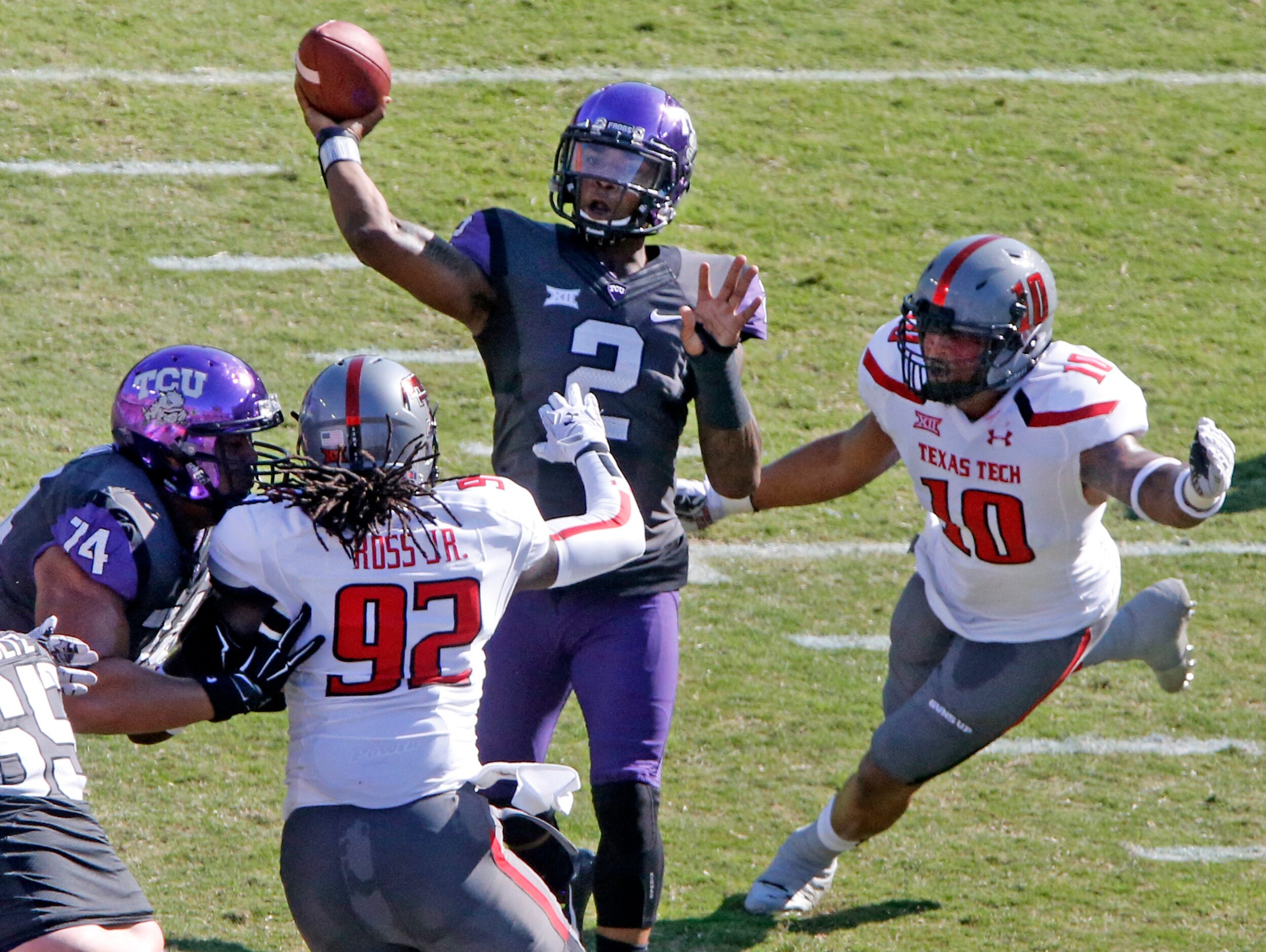 TCU quarterback Trevone Boykin (2) throws a first quarter pass as Texas Tech linebackers...