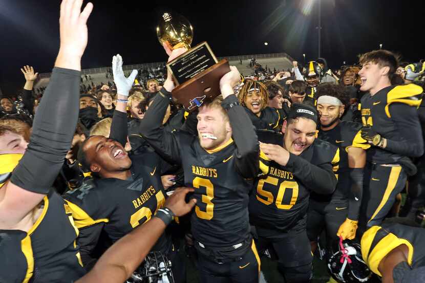 Forney high QB Kyle Crawford (3) holds the game trophy high, as he and his teammates...