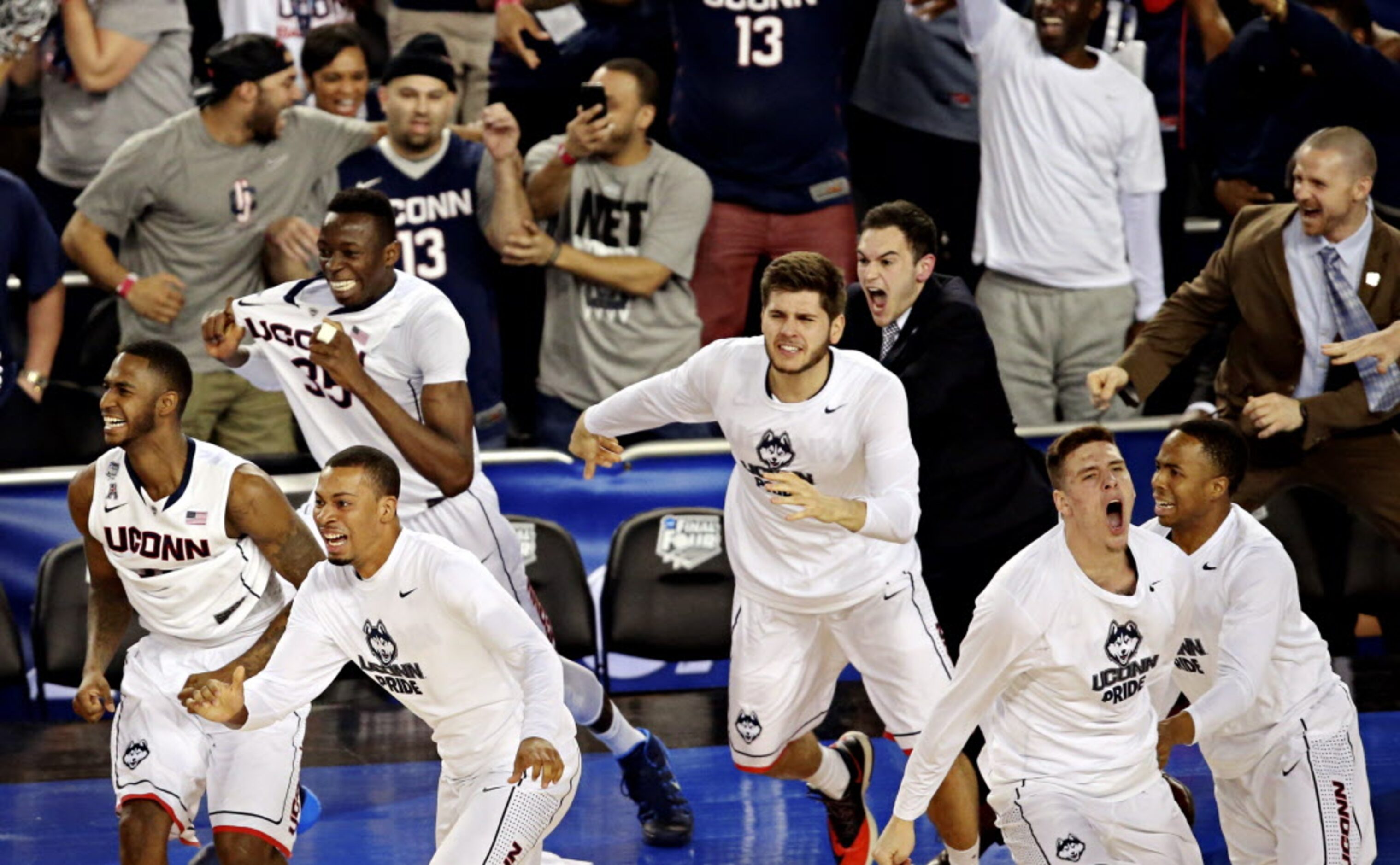 The Connecticut Huskies bench erupts in jubilation following their 60-54 win over the...