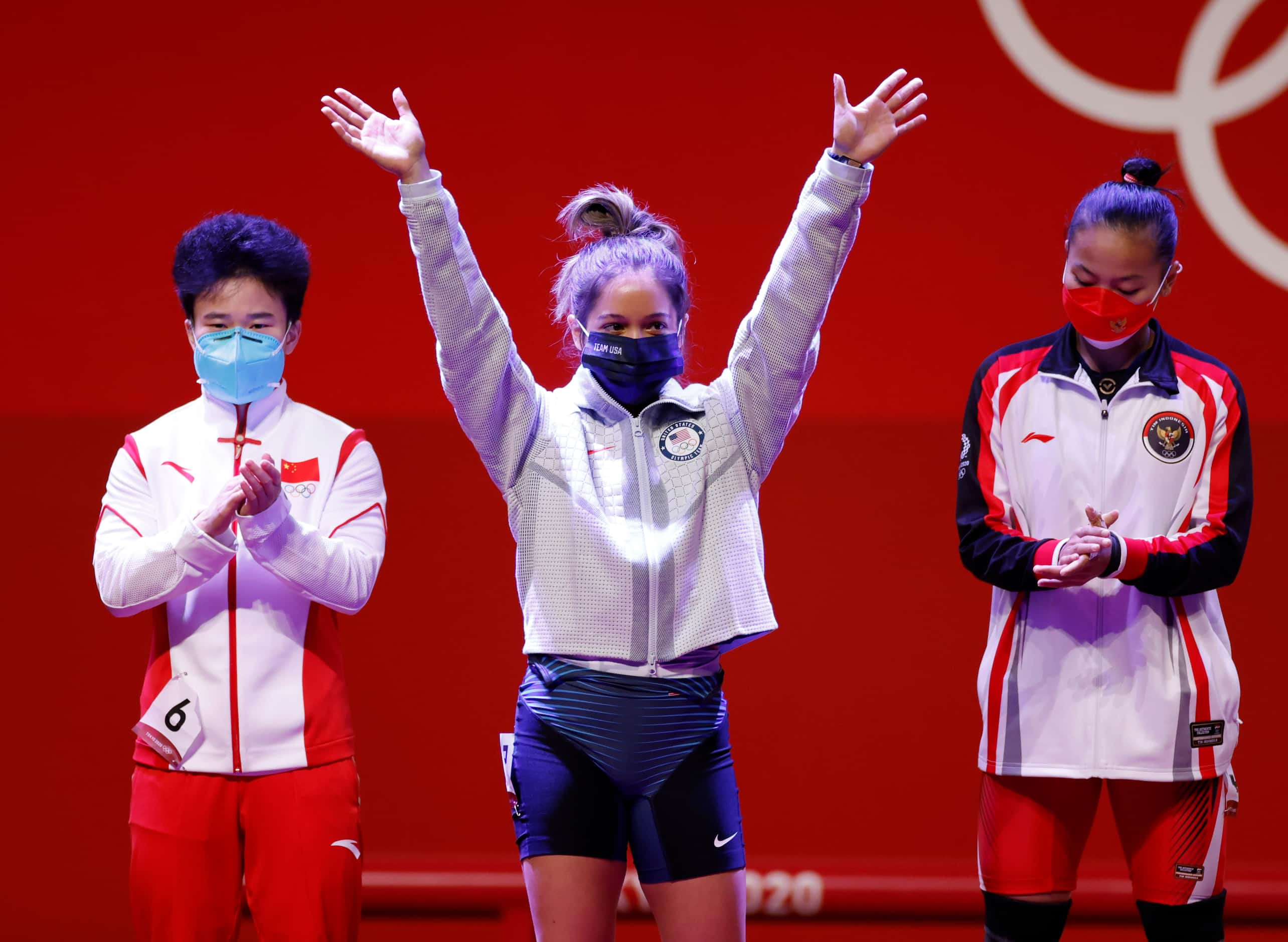 USA’s Jourdan Delacruz waves as she is introduced during the women’s 49 kg weightlifting...