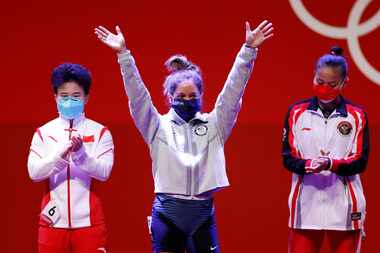 USA’s Jourdan Delacruz waves as she is introduced during the women’s 49 kg weightlifting...